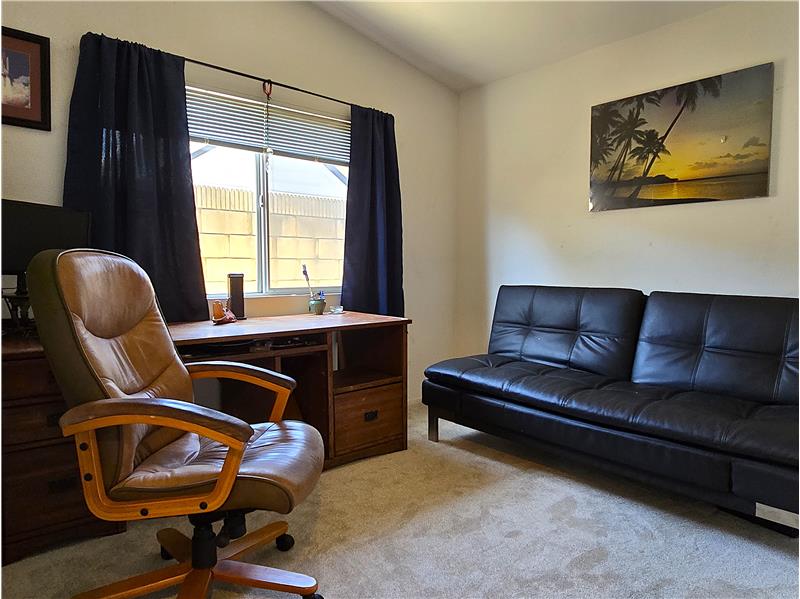 Spacious third bedroom with warm western lightideal for guests or a home office.