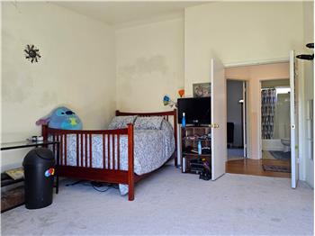 Primary bedroom with doubledoor entry, vaulted ceiling, and flexible layout.