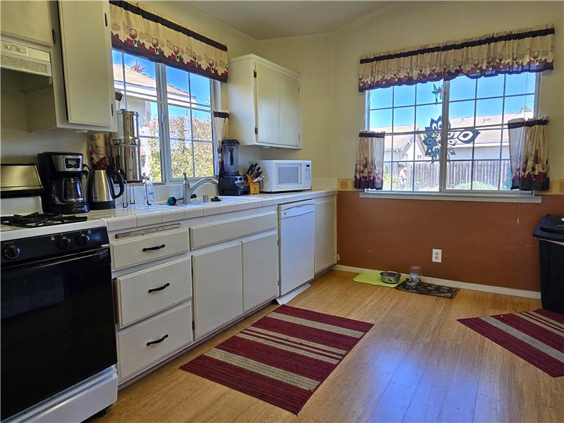 Wake up to warm natural light pouring into a kitchen designed for slow mornings and easy routines.