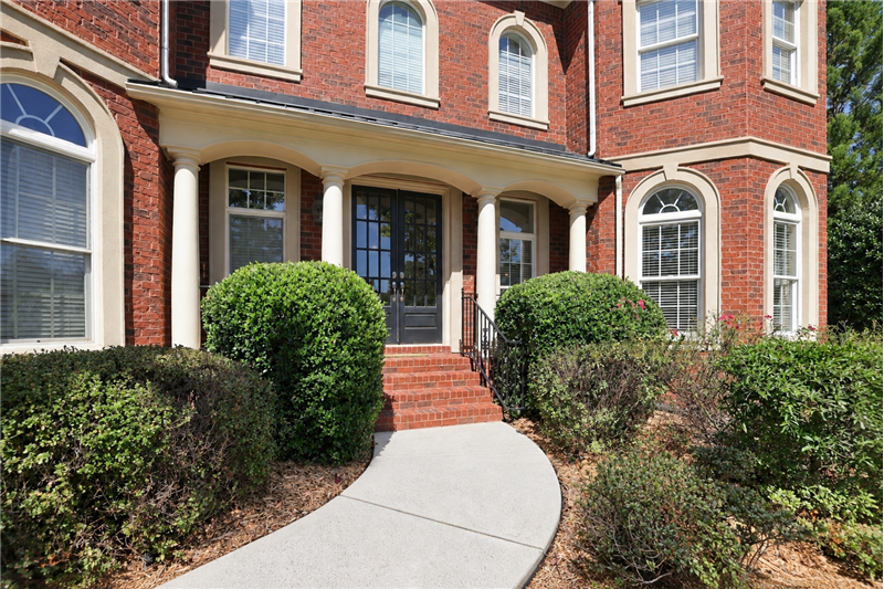Arched windows, contrasting stone-toned trim give the home architectural character well beyond the ordinary.