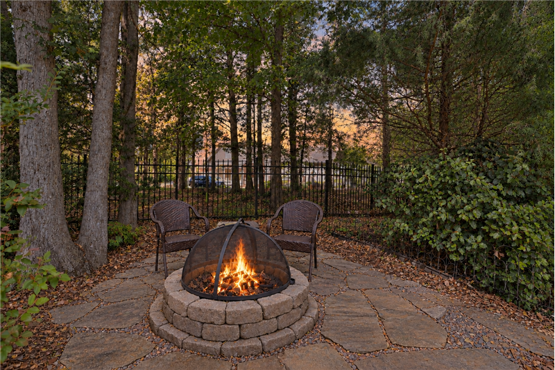 Backyard fire pit creates a cozy spot for relaxing on cool evenings.