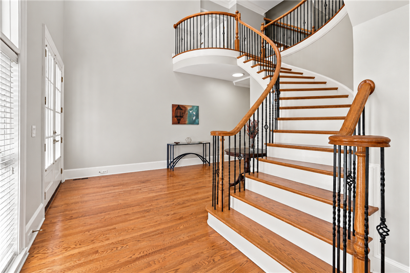 Grand 2-story foyer with sweeping staircase welcomes you inside.