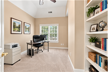Part of the primary suite, office/library with built-in bookshelves creates a quiet, private place to work, relax, read.