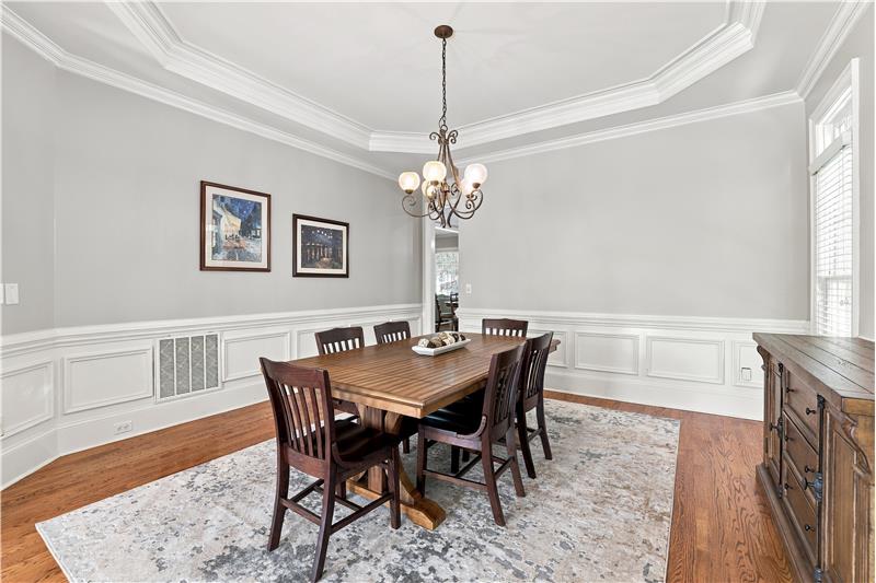Large formal dining room made for celebrations, holiday dinners. Extensive millwork, trey ceiling gives the room a custom feel.