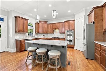 Kitchen for anyone who loves to cook and entertain! Lots of counter space and cabinet storage, large island, double wall ovens.