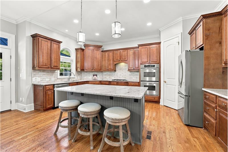 Kitchen for anyone who loves to cook and entertain! Lots of counter space and cabinet storage, large island, double wall ovens.