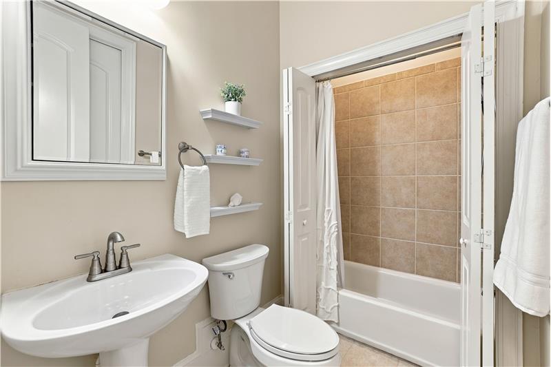 Full bathroom on home's main floor accessed from both the adjoining bedroom and hallway.