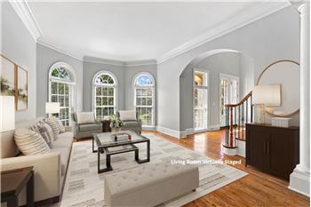 Dramatic arched windows, custom architectural details give the spacious formal living room a luxurious feel.