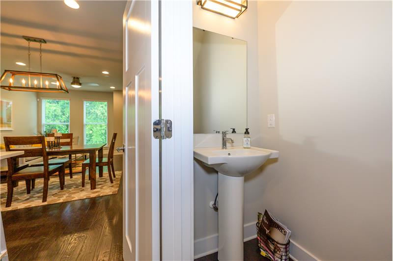 Powder room with contemporary-style pedestal sink and light fixture.