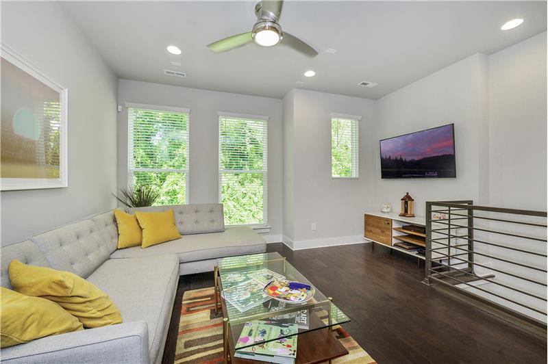 Living room with 9 foot ceilings, recessed lighting, 5 inch hardwood floors, ceiling fan.