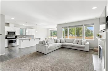 A bright, open-concept floor plan brings the living room, kitchen, and dining area together, with a spacious kitchen island.