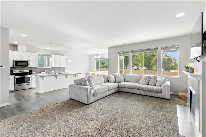 A bright, open-concept floor plan brings the living room, kitchen, and dining area together, with a spacious kitchen island.