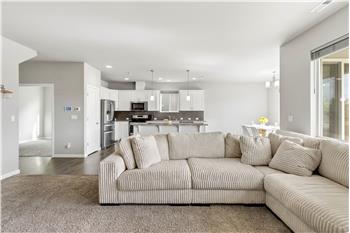 A dedicated main-level home office sits just off the kitchen, offering a convenient workspace close to the homes main living ar
