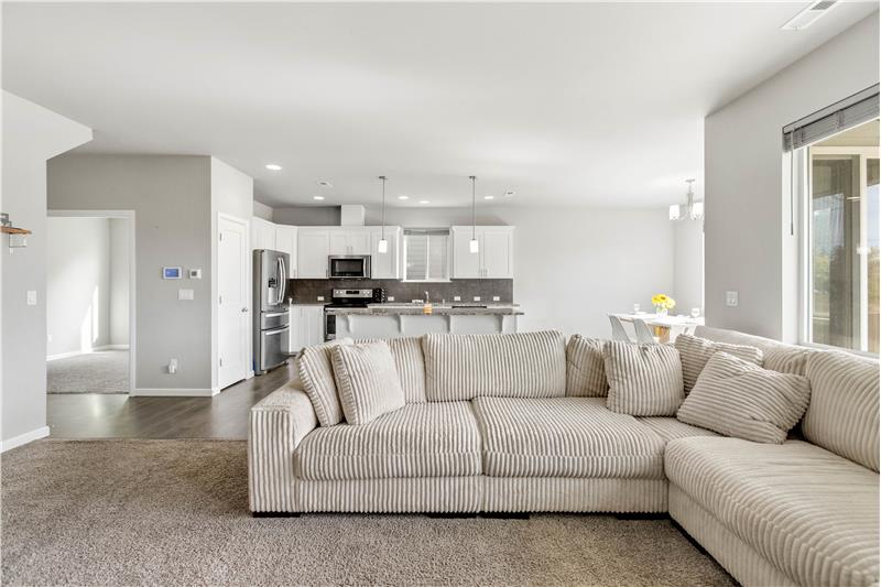 A dedicated main-level home office sits just off the kitchen, offering a convenient workspace close to the homes main living ar