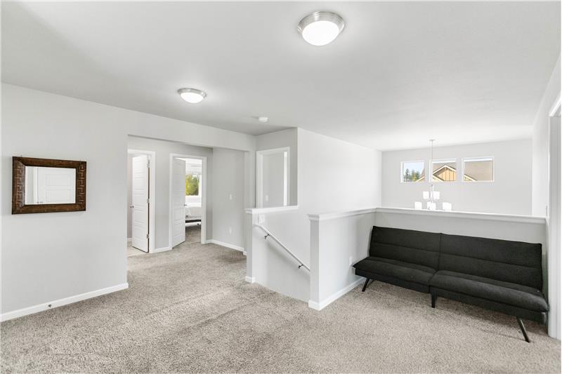 The spacious second-floor landing offers a cozy spot to curl up with a book or enjoy a quiet moment between rooms.