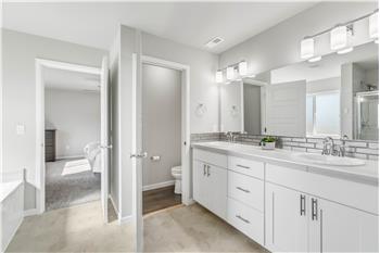 The primary suite connects to a 5-piece en suite featuring dual sinks, a separate water closet, a bathtub, and a shower