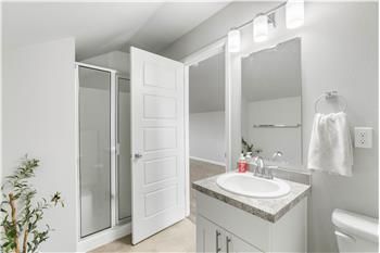 The third-floor three-quarter bath features a shower and vanity, conveniently located just off the bonus room.