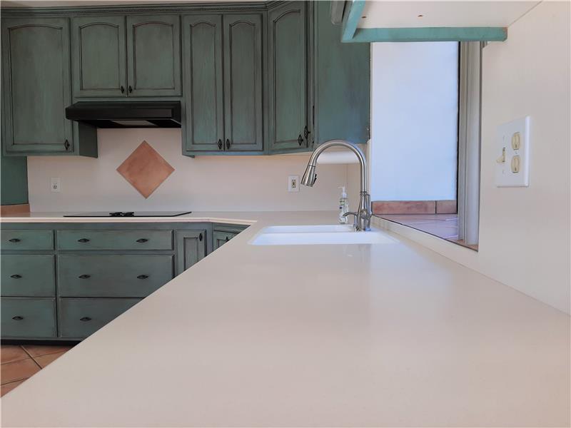 Solid surface counters. Flush mounted sink. Updated fixtures. Impressive!
