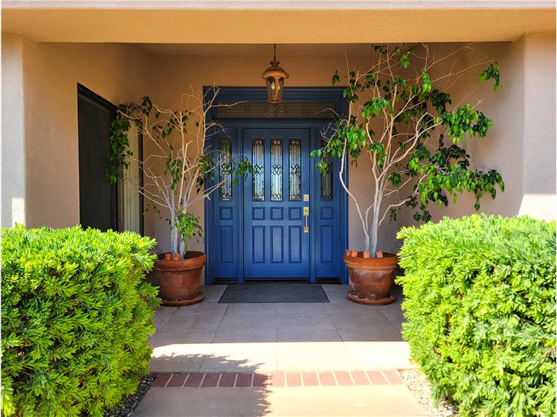 Welcome to 2430 Bayside Place, with its lited door of inlaid glass.