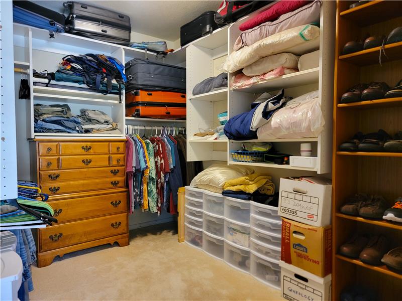 Walk-in Master Closet with integrated shelving.