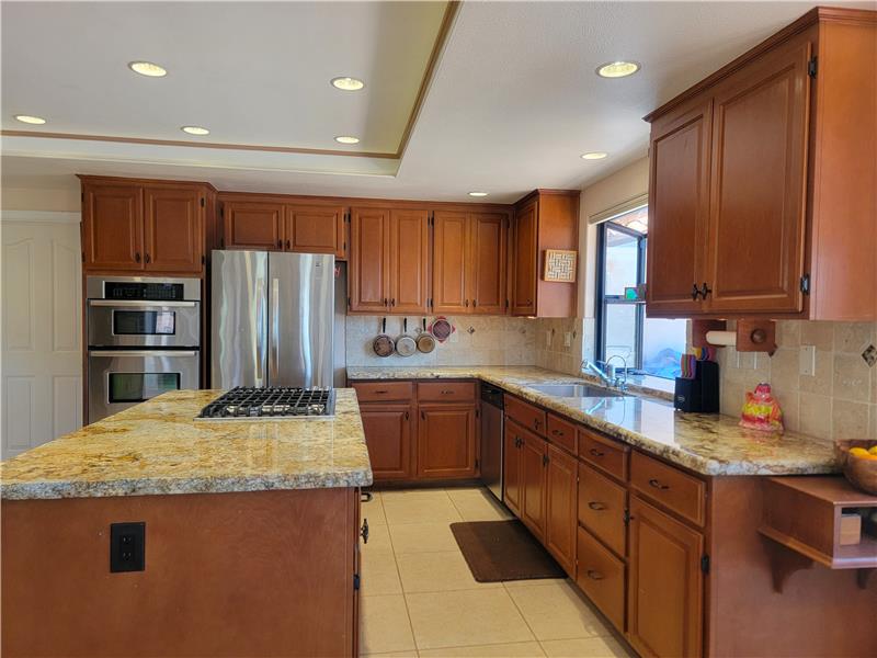 That Trey Ceiling, with 15 recessed lights, covers every inch of this large kitchen come evening time.