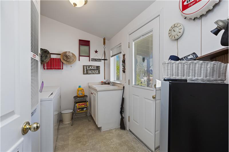 laundry with washer and dryer included adjacent to kitchen