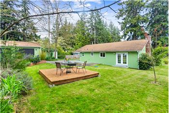 The backyard offers a peaceful setting to unwind on the freestanding deck while enjoying visiting wildlife.