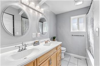 The main bathroom offers plenty of space and includes double sinks.