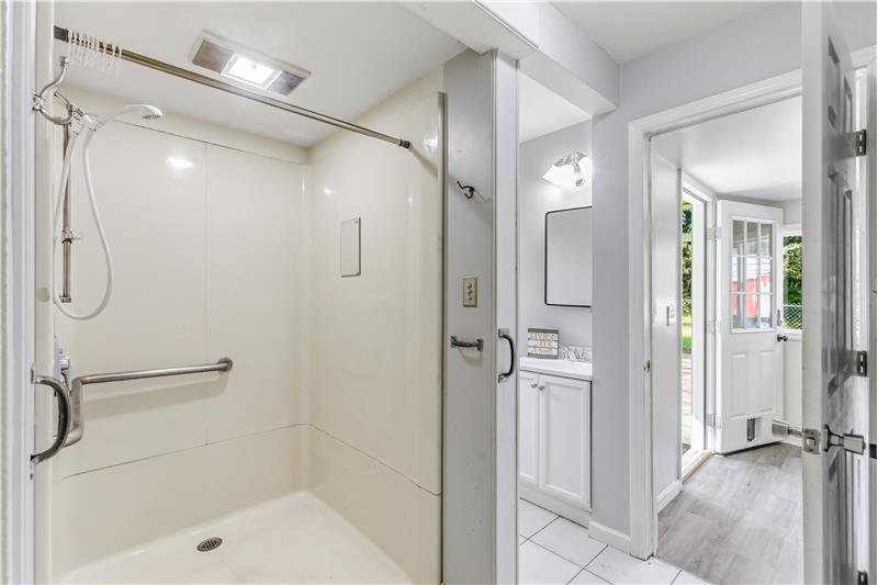 The bathroom features a walk-in shower with grab bars and a no-step entry for added ease of access.