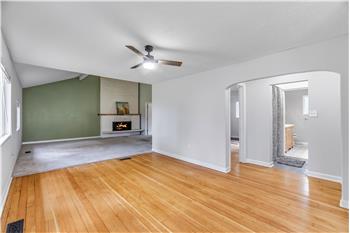 Entering the home, you are greeted by restored original wood floors.