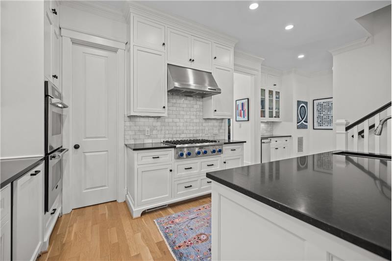 Kitchen: stainless Thermador 6-burner cooktop with hood, double wall ovens, butler's pantry with ice-maker and cabinet storage.