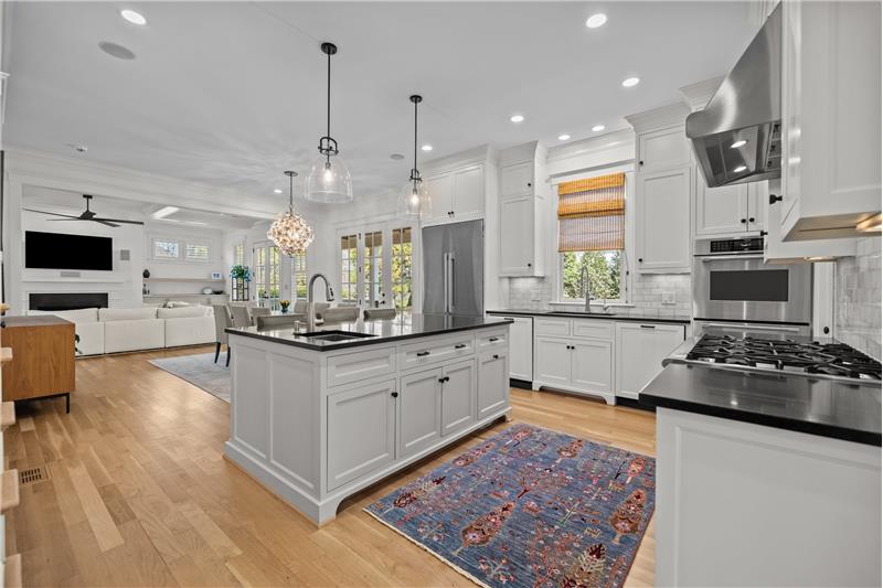Open sight lines from kitchen allow for both hosts and guests to mingle and socialize with ease.