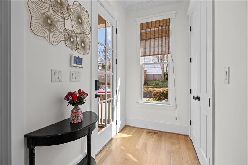 Side entrance to home leads to a sunny, spacious foyer. Convert the large closet to a drop zone.
