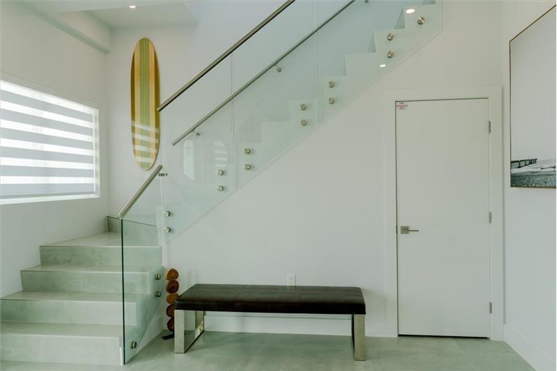 Foyer & stairs leading up to the master suites and additional bedrooms.