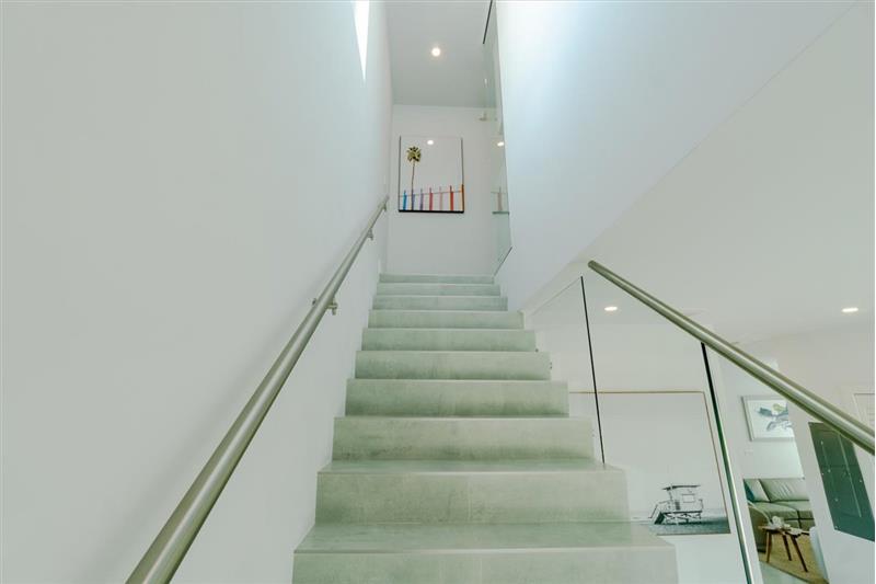 Stairs leading up to the master suites and additional bedrooms.