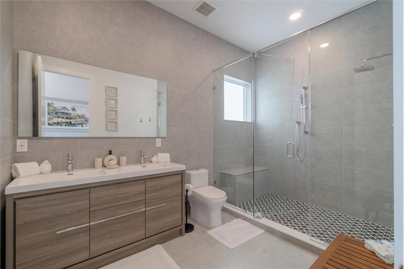 Dual vanity master bathroom with luxurious walk-in shower.