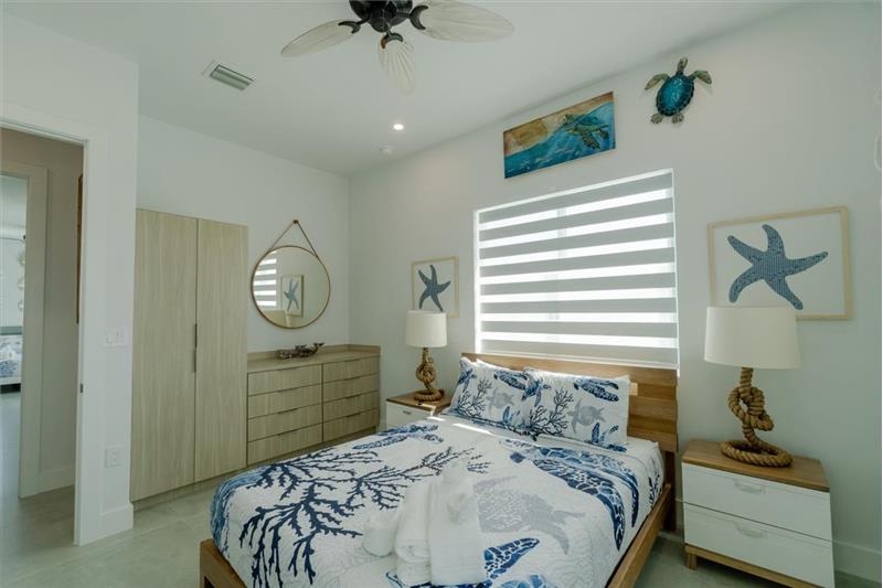 Queen bedroom with ensuite bathroom and smart TV.