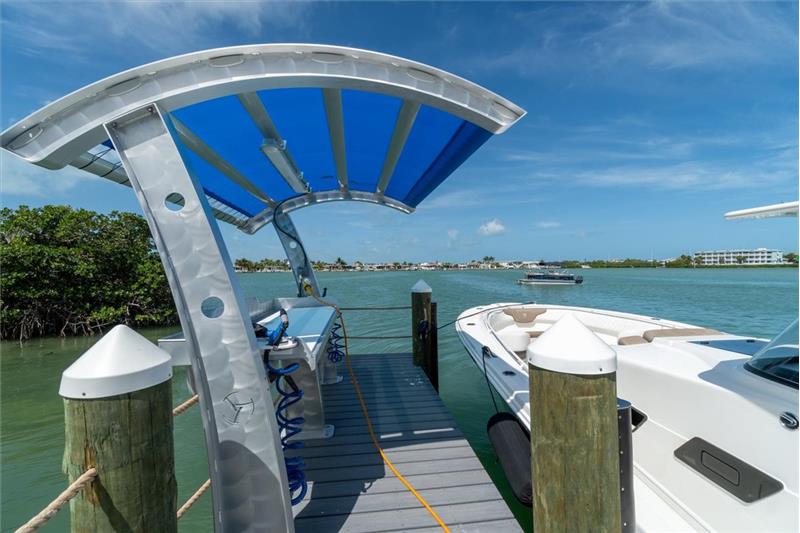 Shaded fish-cleaning station with water and power. Boat for scale but not included.