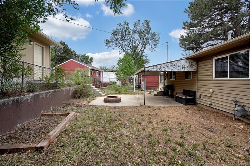 Fenced Lot with Covered Patio, Fire Pit, and Storage Shed