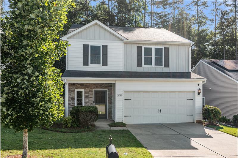 Covered entry with room for seating. 2- car garage.