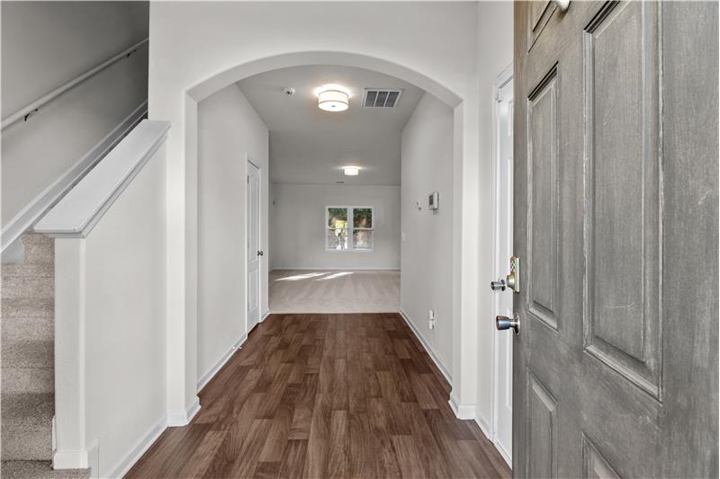 Spacious foyer with arched entry; freshly painted