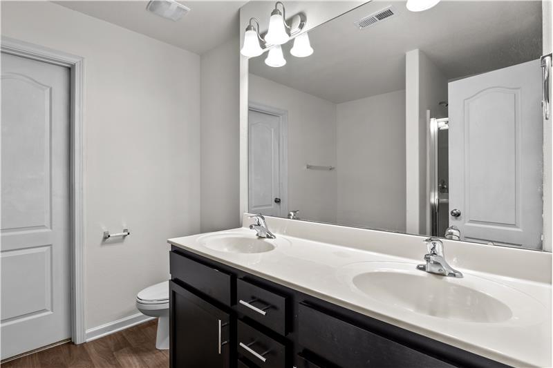 En-suite primary bathroom with double sink vanity