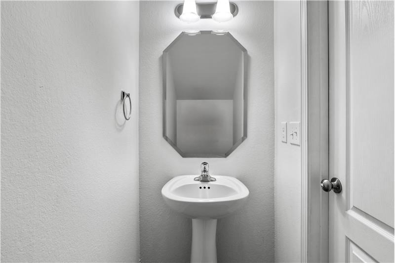 Half bath on main floor feature pedestal sink