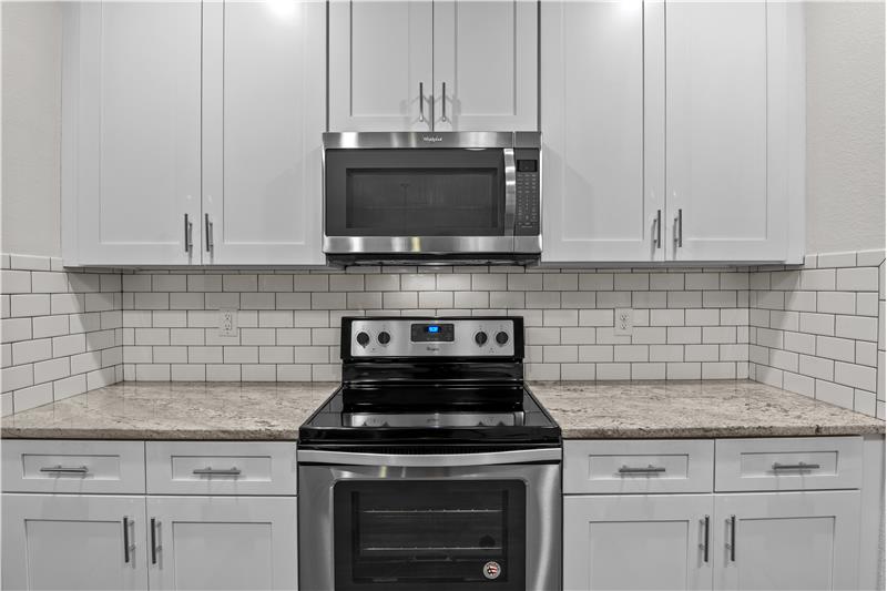 Kitchen features soft close drawers, tile backsplash