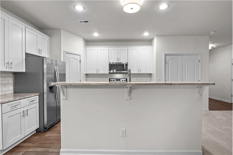 Breakfast bar in kitchen with granite countertop