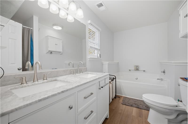 Dual sinks and soaking tub in the primary bedroom