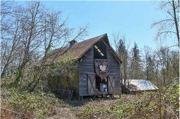 Barn as seen from the north with shed/shop roof in backdrop