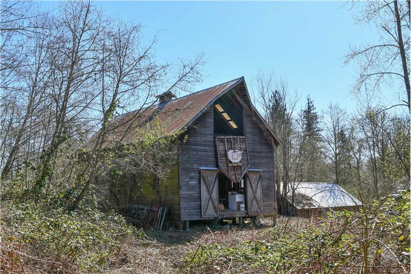 Barn as seen from the north with shed/shop roof in backdrop