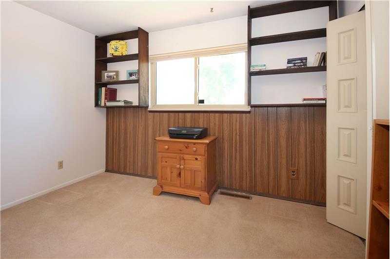 Main Level Bedroom #2 with Built-In Shelves and Paneled Wall