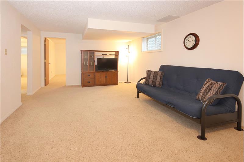 Remodeled Basement Rec Room with Futon, Entertainment Center, and Flat Screen TV